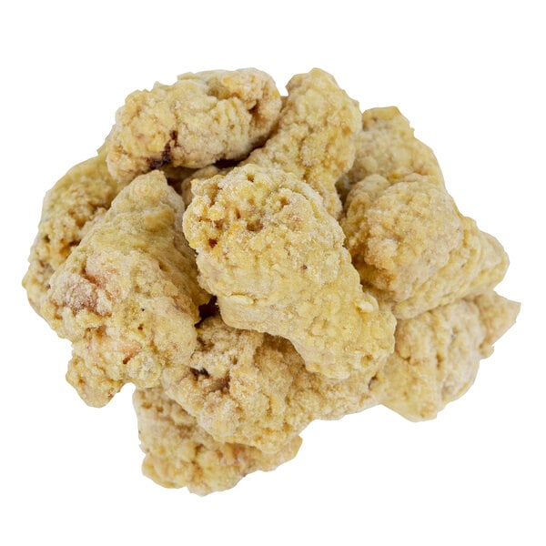 A pile of Brakebush Honey Touched Battered Chicken Wing Drummettes on a white background.