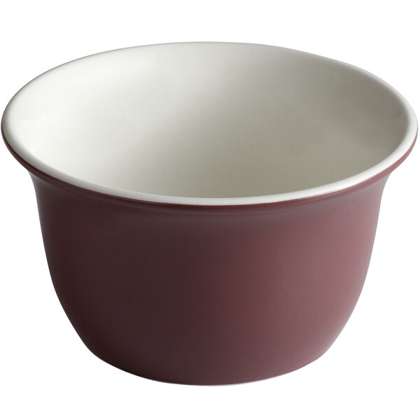 A close-up of a Libbey Englewood matte mulberry soup bowl with white and red rims.