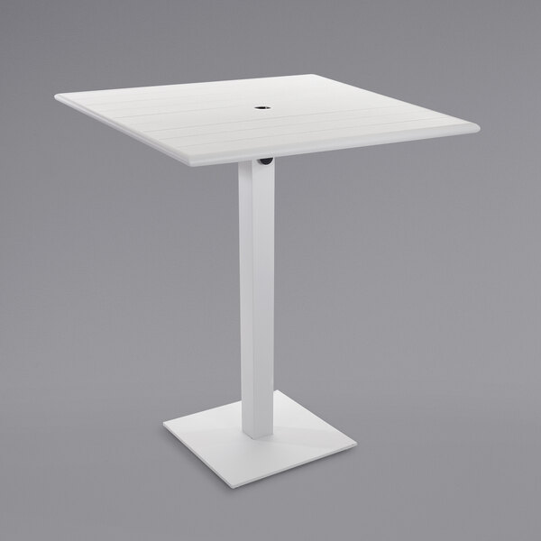 A white square BFM Seating Beachcomber-Margate bar height table with a square base and umbrella hole.