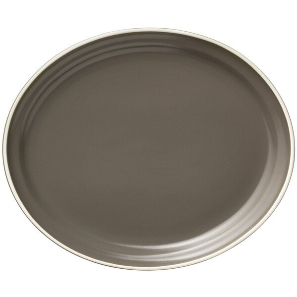 A close-up of a Libbey matte olive oval platter with a white rim.