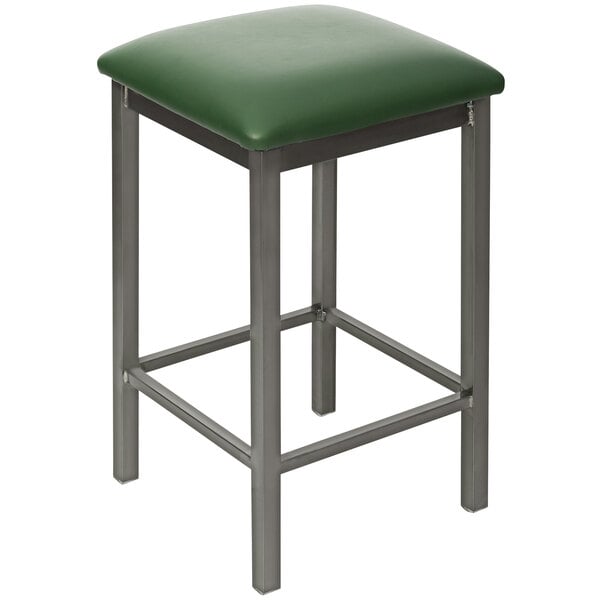 A BFM Seating counter height bar stool with a green seat and metal legs.