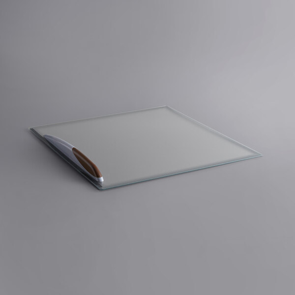 A white glass top lid with a brown handle.