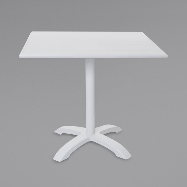 A white rectangular BFM Seating dining table with a white powder coated aluminum base.