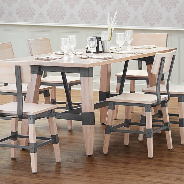 A Lancaster Table & Seating live edge wood table with chairs and glasses on it.