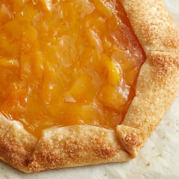 A pie with Lucky Leaf Premium Peach filling on a table.