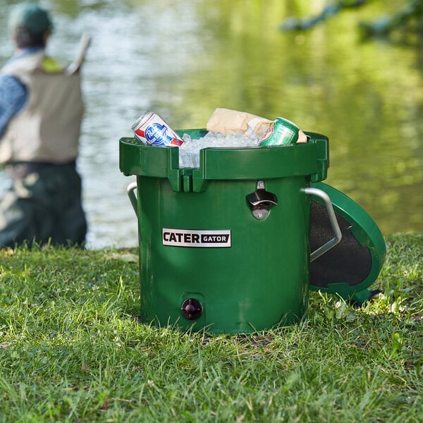 A green CaterGator outdoor cooler filled with ice and cans.