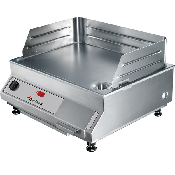 A large stainless steel Garland countertop induction griddle.