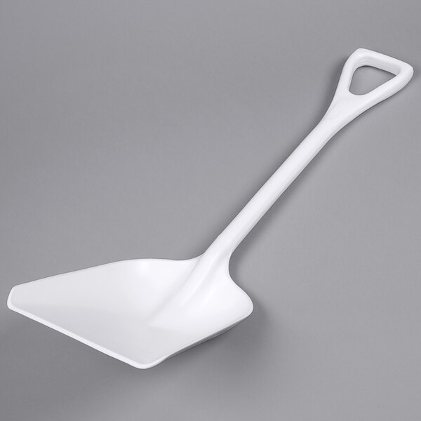 A white plastic shovel for ice on a gray background.