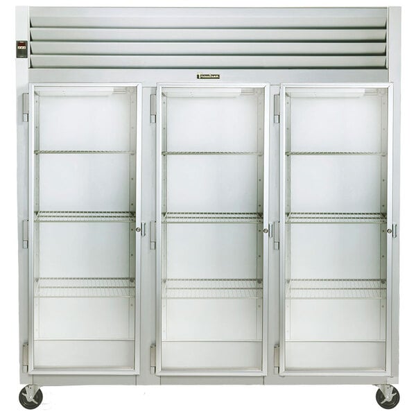 A white Traulsen reach-in refrigerator with three glass doors and shelves.