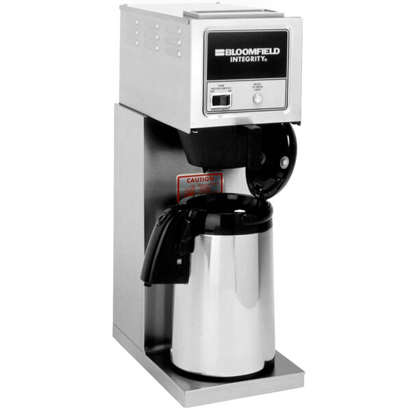 A silver Bloomfield commercial pourover coffee maker with a black label on a counter.