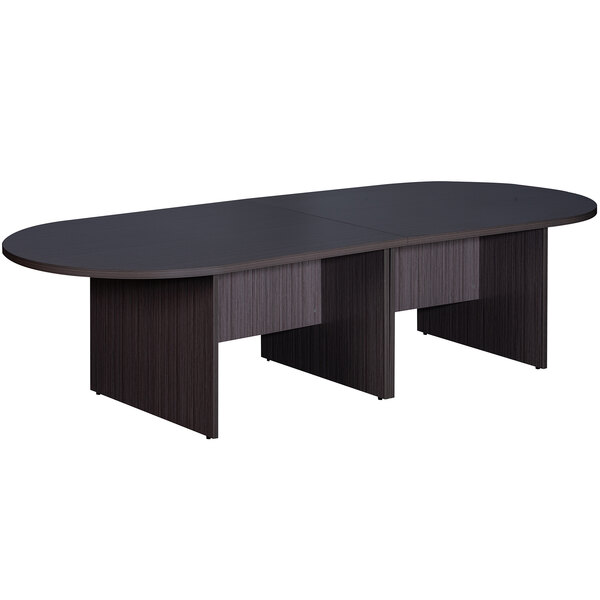 A Driftwood laminate oval conference table with black edges and two black bases.