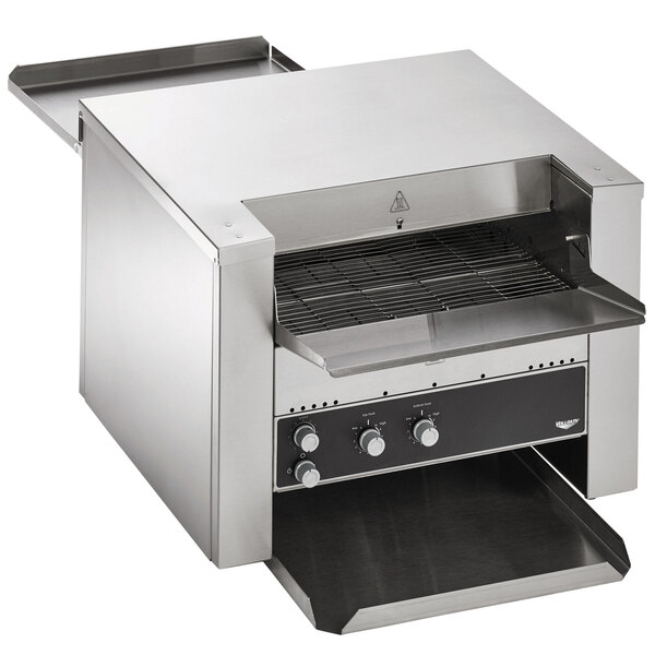 A Vollrath conveyor toaster on a counter in a stainless steel oven.