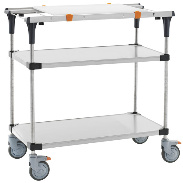A silver cart with three shelves, a cutting board, and stainless steel shelving on wheels.
