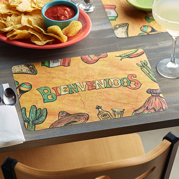 A table with a plate of chips and a Choice Mexican themed paper placemat.