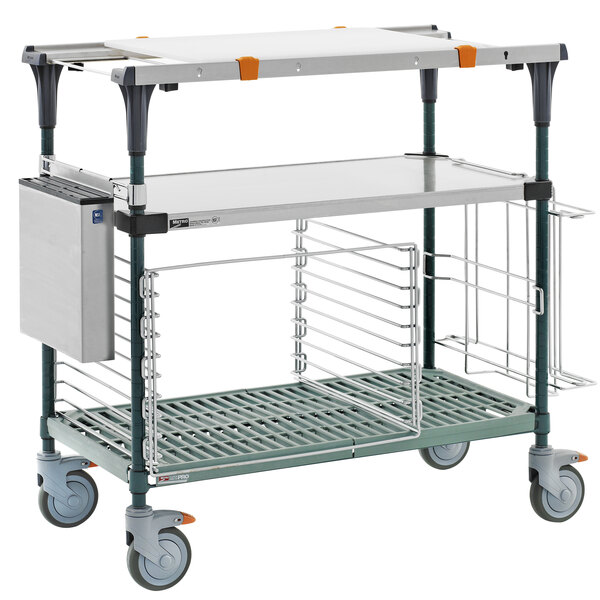 A Metro stainless steel cart with a shelf and a metal tray on it.