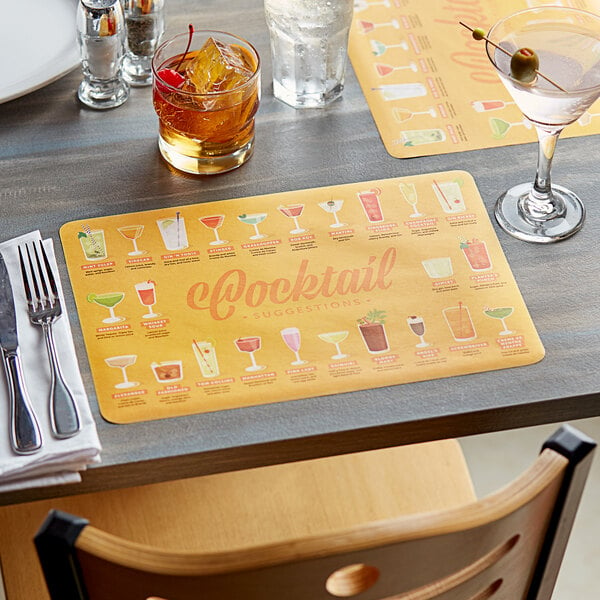 A table set with a Choice paper placemat that says "Cocktail Suggestions" with glasses of drinks on it.