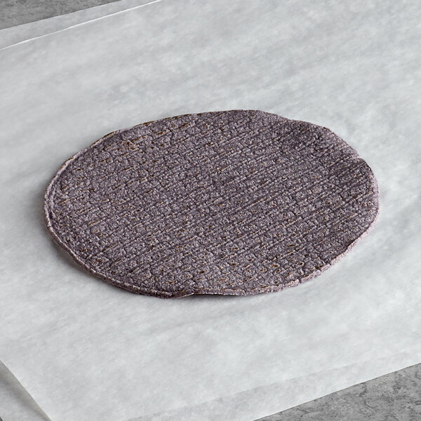 A purple Mission tortilla on a white surface.