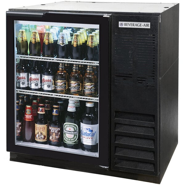 A Beverage-Air black back bar refrigerator filled with bottles of beer.