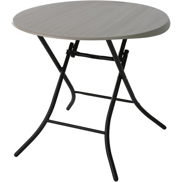A Lifetime round folding table with a putty table top.