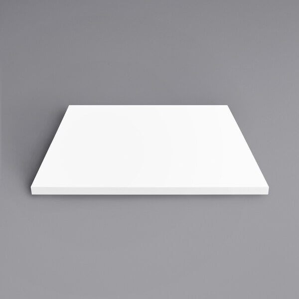 A white square Art Marble Furniture Winter White Quartz Tabletop on a gray background.