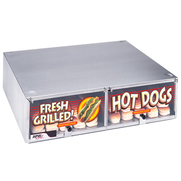 An APW Wyott hot dog bun cabinet on a counter with hot dogs inside.