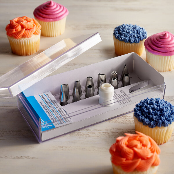 A box of Ateco icing tips with cupcakes on a counter.