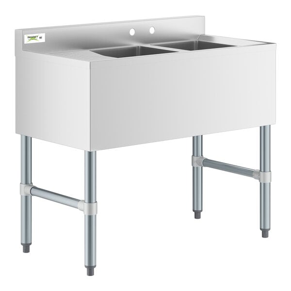 A stainless steel Regency underbar sink with two bowls and a left drainboard.