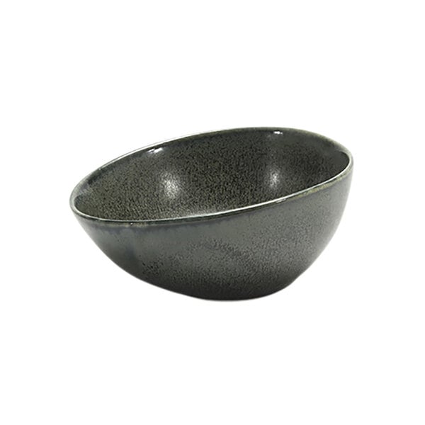 A sage green porcelain ramekin with a hole in the middle.