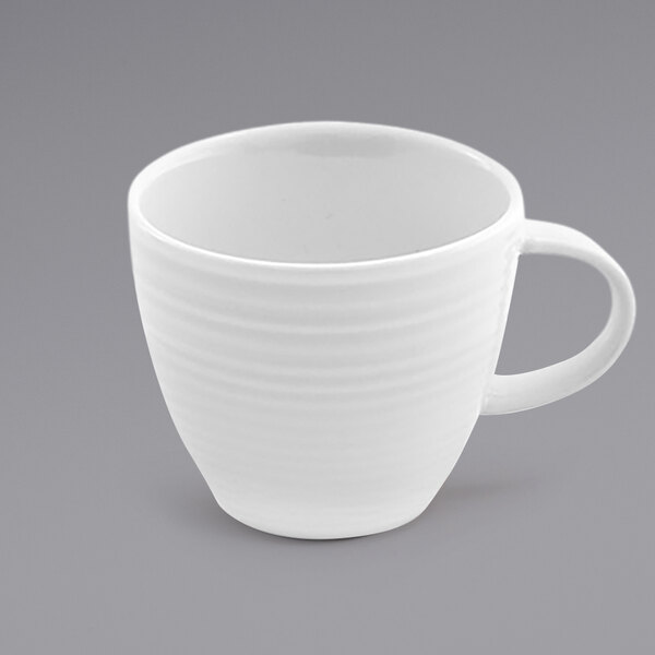 A close-up of a white Front of the House Spiral espresso cup with a white background.