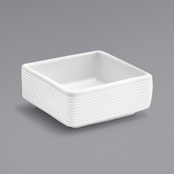 A white square Front of the House Spiral ramekin with a square ribbed design.