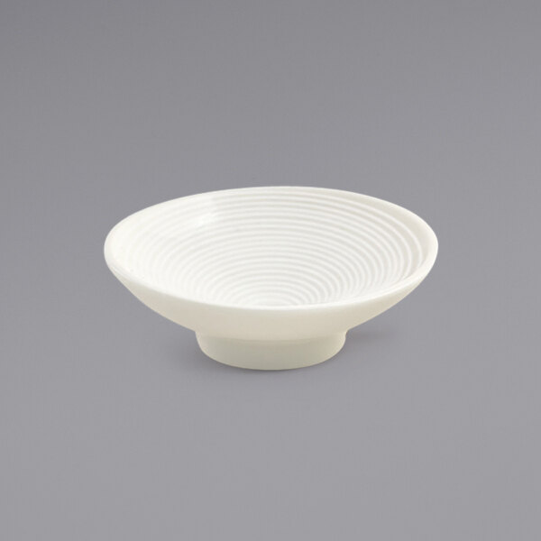 A white Front of the House ramekin with a spiral pattern.