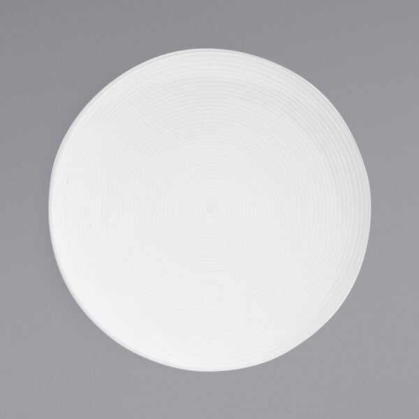 A white porcelain plate with a spiral pattern on it.