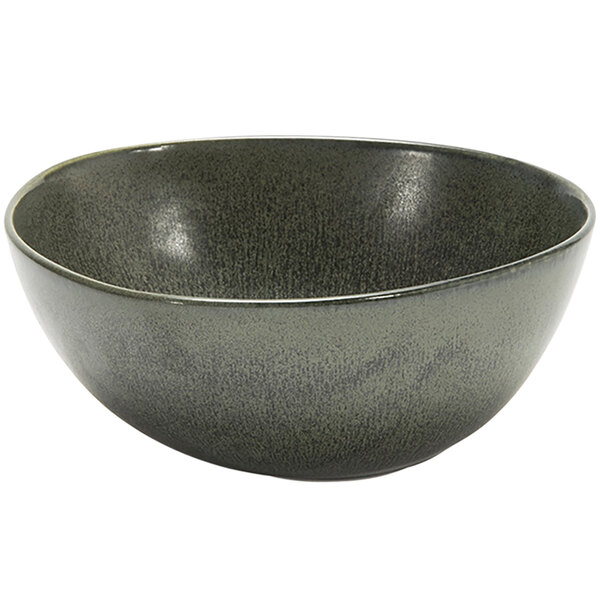 A sage green bowl with a speckled texture and a black rim.