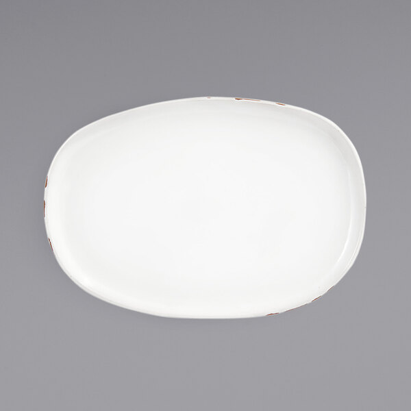 A white oval porcelain plate with brown edges.