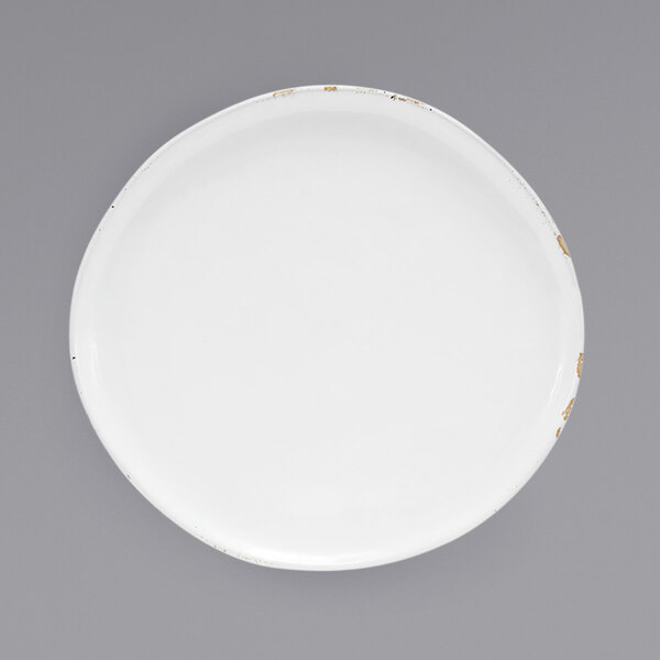 A Front of the House white porcelain plate with gold trim.