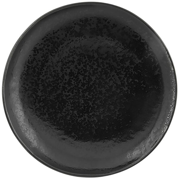 A black porcelain plate with specks on the rim.