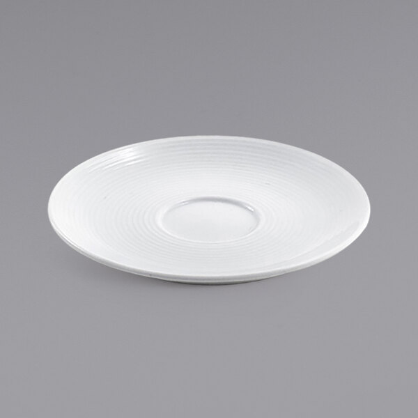A white porcelain saucer with a spiral pattern on the rim.