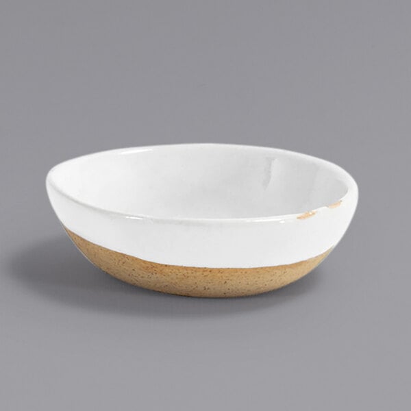 A white Front of the House Artefact porcelain ramekin with a brown rim.