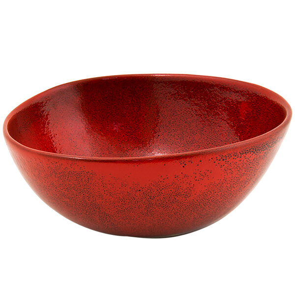 A close up of the red surface of a Kiln chili bowl.