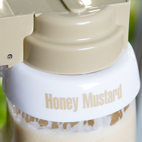 A white Tablecraft salad dressing dispenser collar with beige lettering that says "Honey Mustard" on it.
