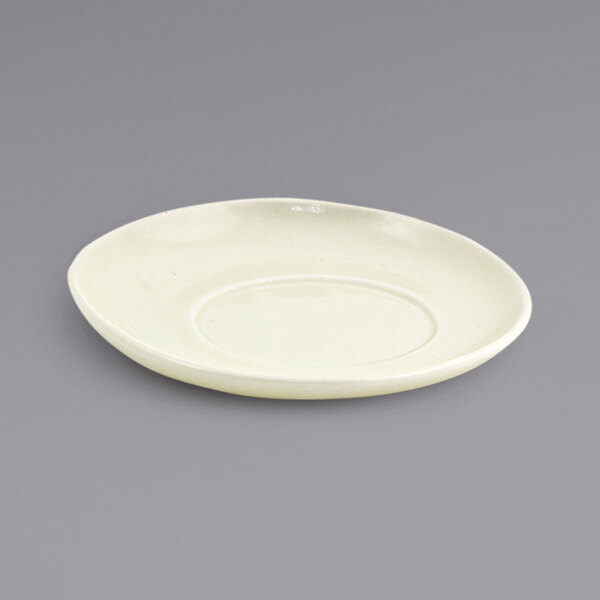 A white porcelain saucer with a circular shape.