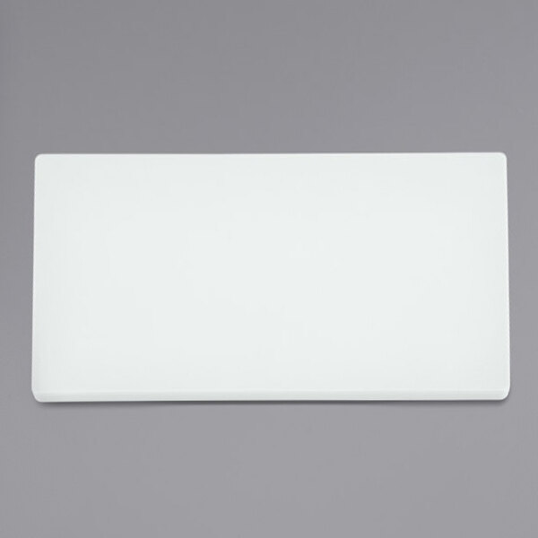 A white rectangular Vollrath cutting board.