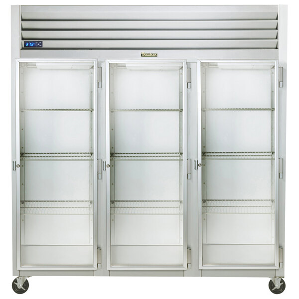 A white Traulsen G Series reach-in refrigerator with three glass doors and shelves.