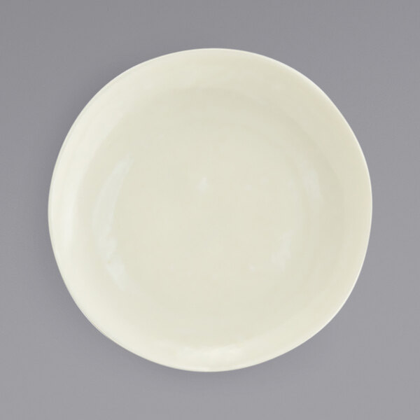 A close up of a white Front of the House Kiln porcelain plate with a small rim.
