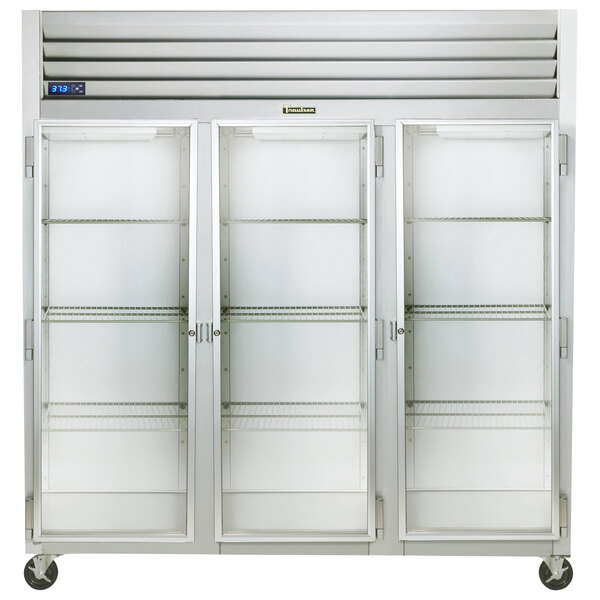 A large Traulsen reach-in refrigerator with three glass doors and white shelves.