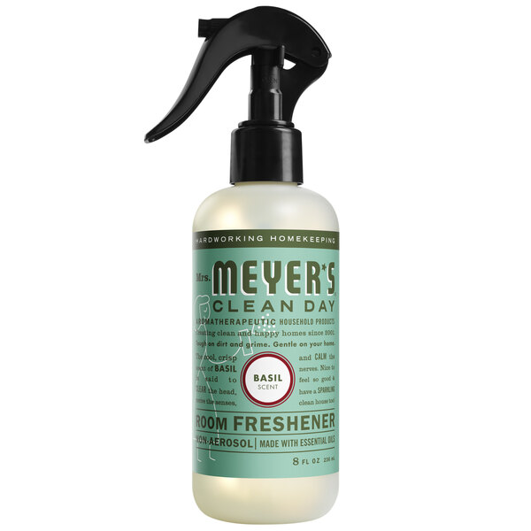 A bottle of Mrs. Meyer's Basil Air Freshener spray with a green label and black sprayer.