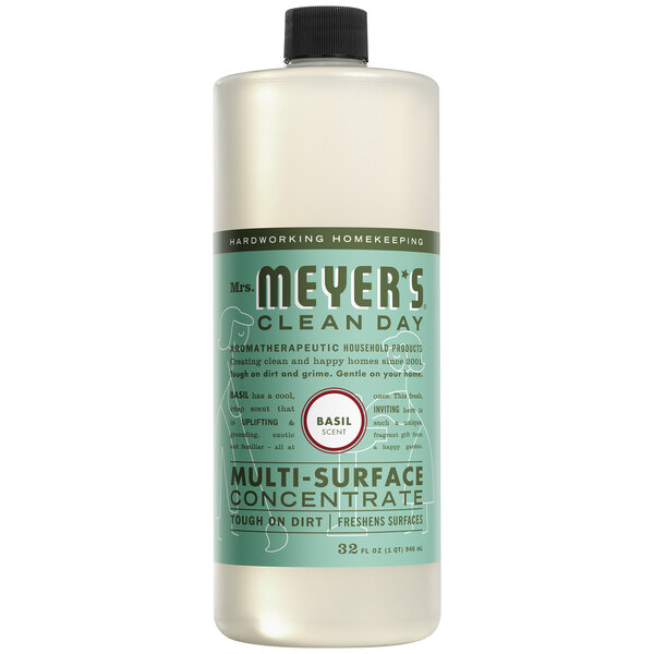 A bottle of Mrs. Meyer's Basil Multi-Surface Cleaner concentrate on a counter.