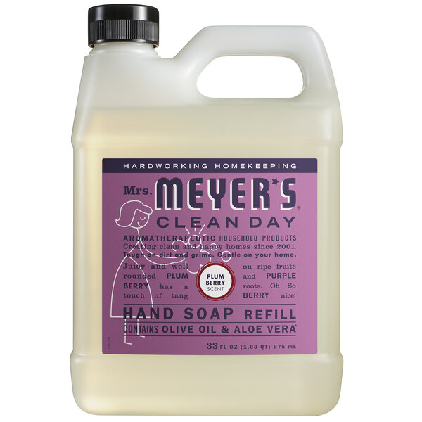 A white jug of Mrs. Meyer's Clean Day Plum Berry scented hand soap on a counter.