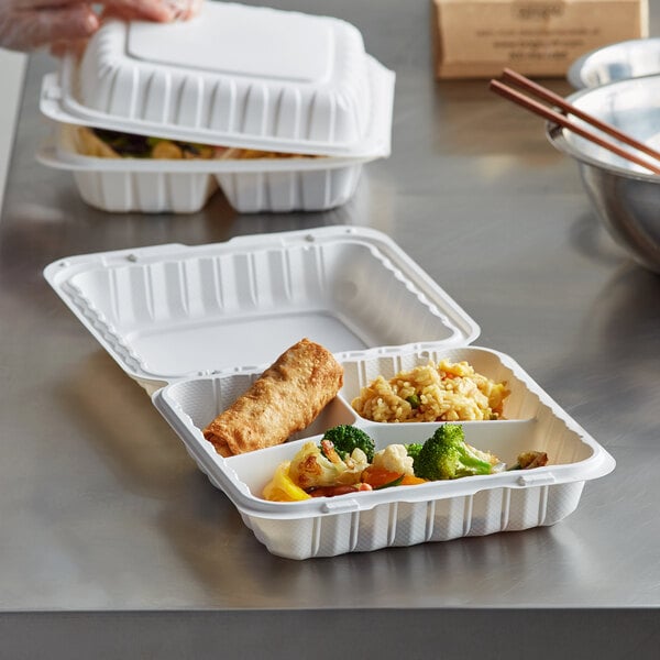 A person using an Ecopax 3-compartment hinged take-out container to prepare a meal.