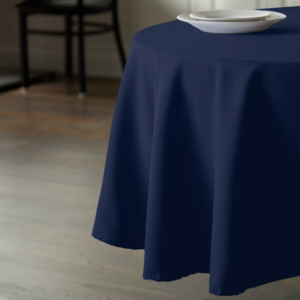 A table with a navy blue tablecloth on it.
